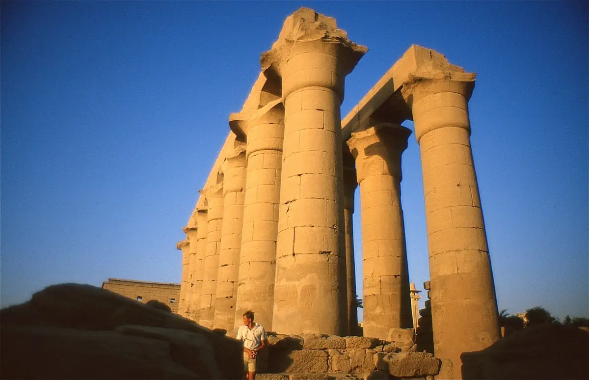 Tall sandstone columns of the colonnade at Luxor Temple in late sunlight