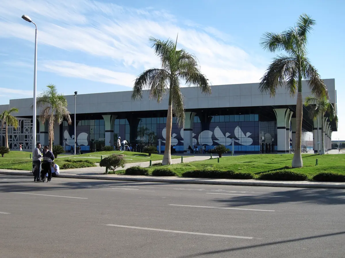 Terminal building of Luxor International Airport with palm trees