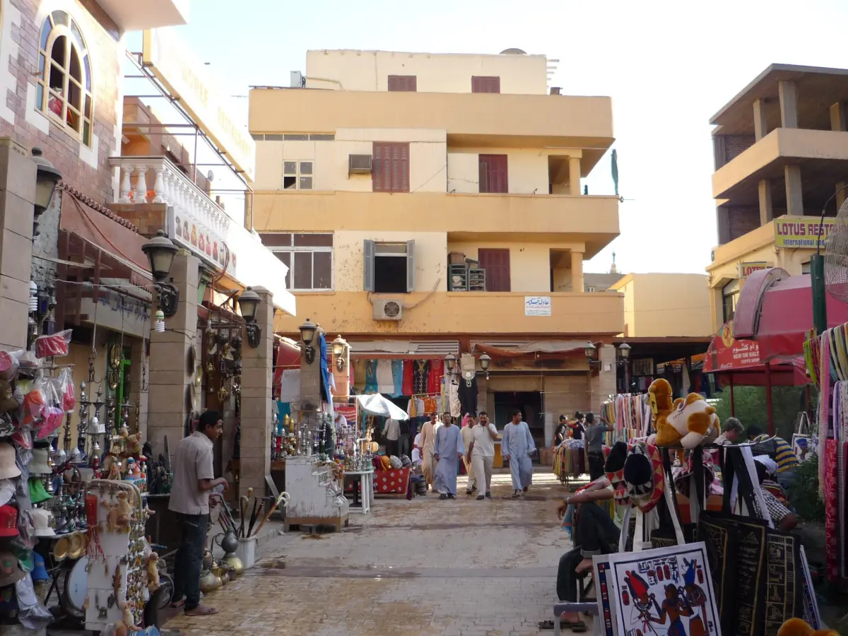 Lane in the Luxor souk with souvenir stalls and small shops