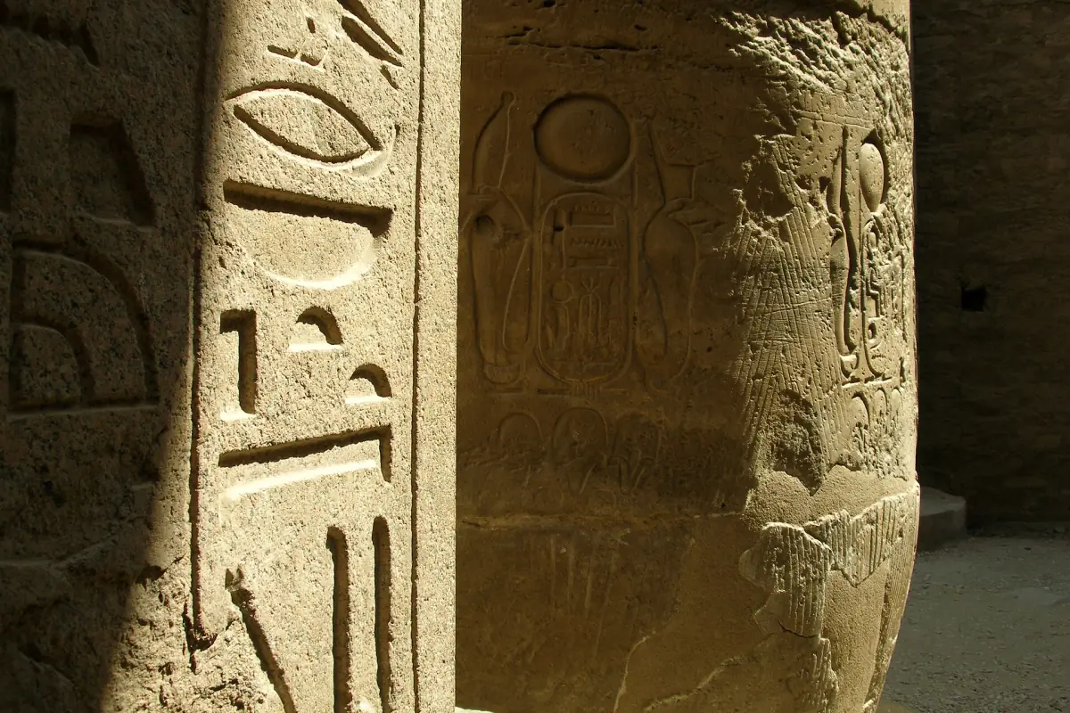 Hieroglyphs carved into a stone pillar inside Luxor Temple